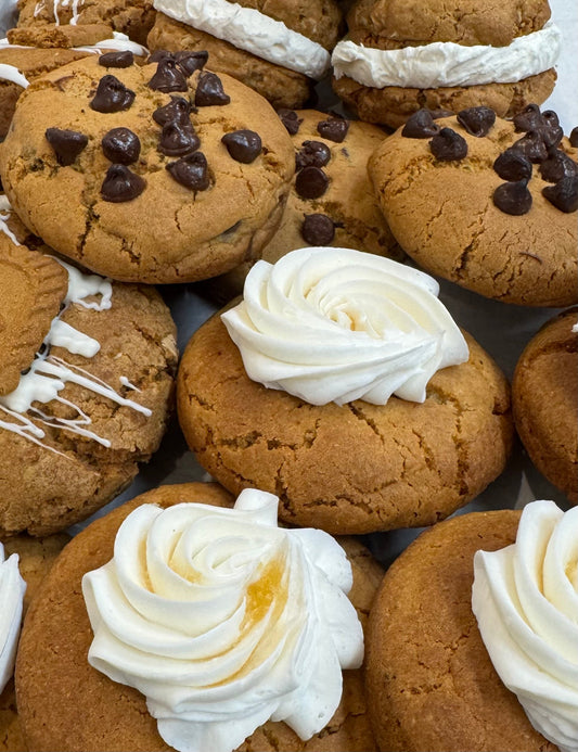 Cookies with white frosting and chocolate chips on a tray